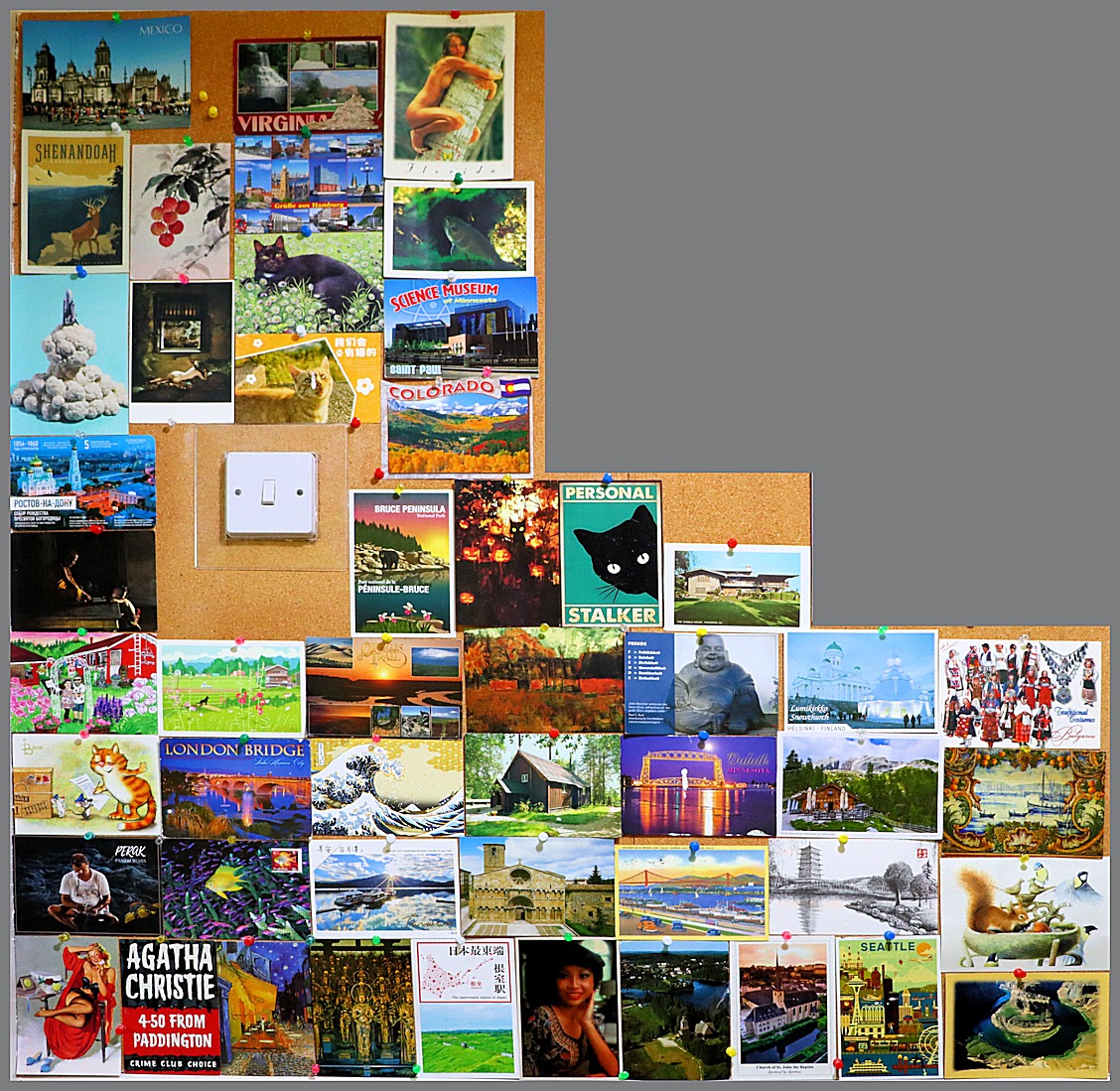 cork board display of postcards