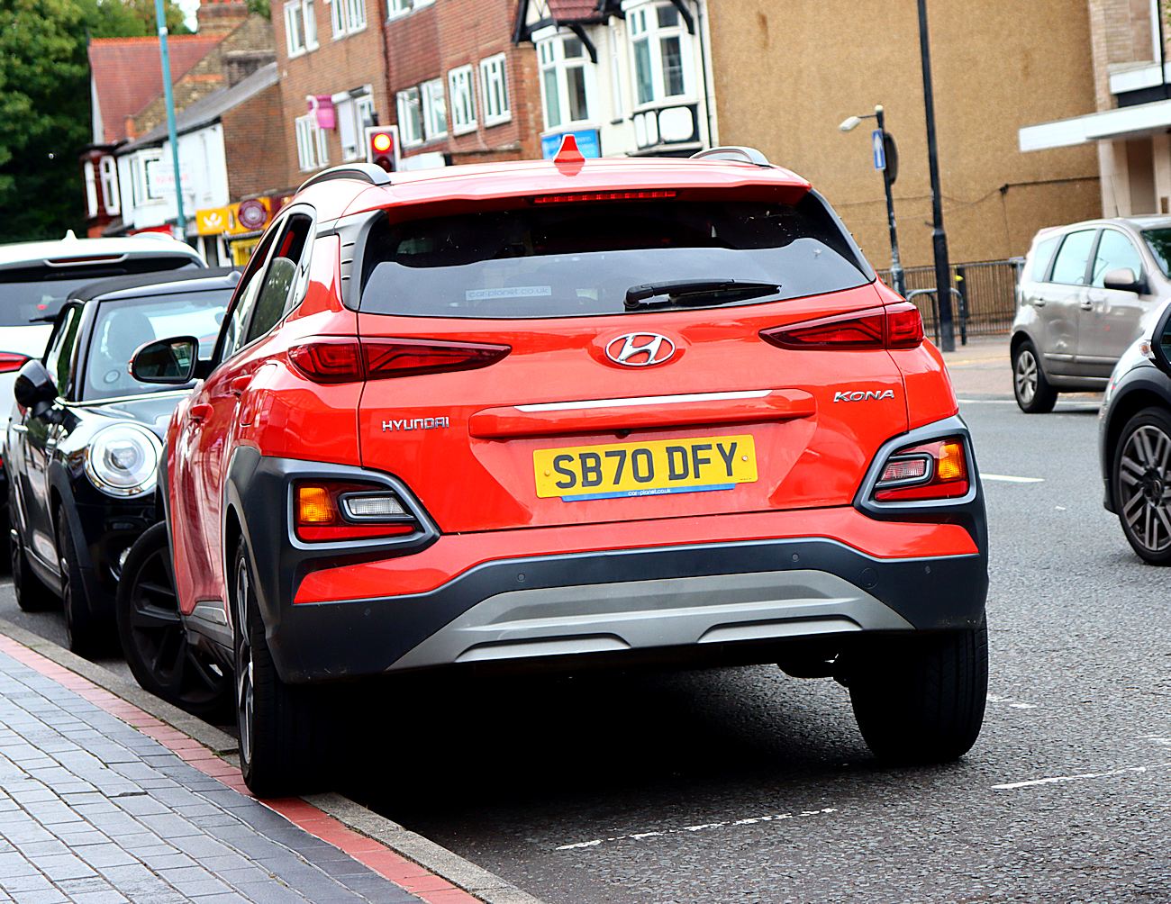 red car badly parked